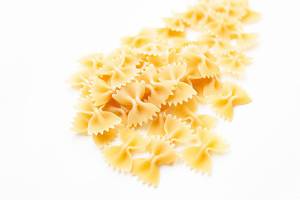 Uncooked dry farfalle pasta isolated on white background  Flip 2019