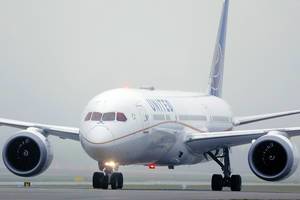 United Airlines Dreamliner 10 plane in Munich Airport, fog
