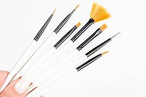 Various makeup brushes in a woman