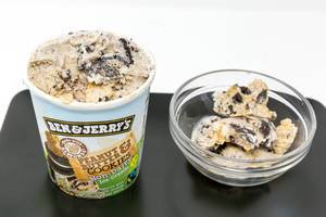 Vegan Ben and Jerrys Ice Cream with peanutbutter and cookies flavour, non dairy in a glas bowl with packaging