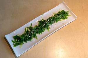 Vegan food from East Asia in a Japanese restaurant, served as algae salad "Goma Wakame" with sesame seeds