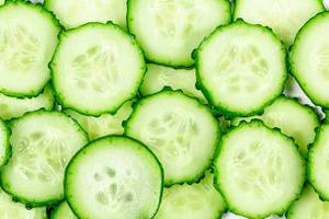 Vegetable background with sliced cucumbers