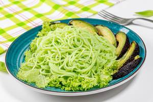 Vegetarian lunch-green spaghetti with avocado and lettuce (Flip 2019)