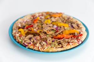 Vegetarian Protein Pizza mit Flaxseeds, Quinoa and pulled Soybeans from Garden Gourmet frozen on a plate