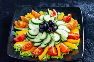 Vegetarian salad with lettuce, tomatoes, cucumber and olives  Flip 2019