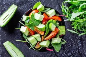 Vegetarian salad with tomatoes, cucumbers and herbs