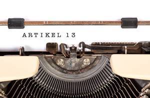 Vintage typewriter from above and written "Artikel 13" as a symbol for the debate about copyrights in the EU