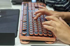 Visitor typing on an Azio Retro Classic keyboard