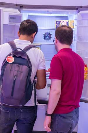 Visitors checking out a digital, smart refrigerator