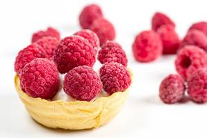 Waffle basket with whipped cream and fresh raspberries