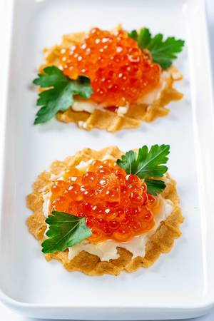 Waffles with cheese cream and red caviar