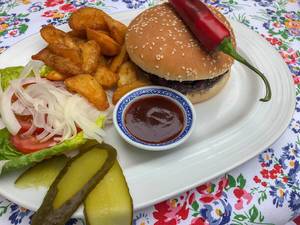 Wagyu Beef Burger with salad, cucumber, onion, tomato, chili pepper, french fries and barbecue sauce