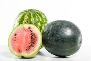Watermelons of different varieties on a white table