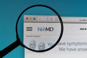 WebMD logo under magnifying glass