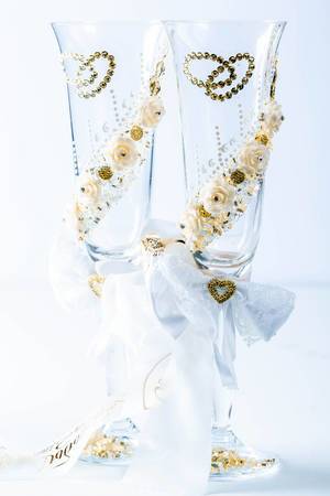 Wedding glasses and wedding decor with ribbon on white background