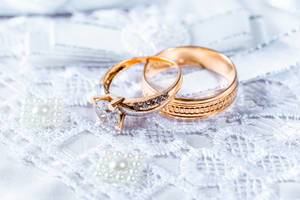 Wedding rings on a lace stand close-up