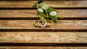 Wedding rings on a wooden table  Flip 2019