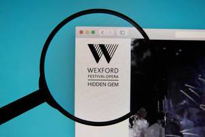 Wexford Festival Opera logo on a computer screen with a magnifying glass