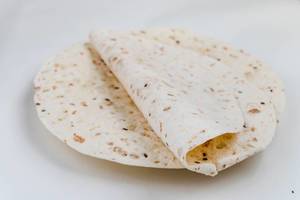 Wheat tortillas for wraps on a plate and a white background