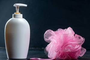 White bottle with shower gel and washcloth