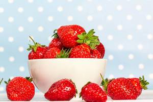 White bowl full of strawberries