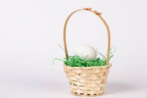 White chicken egg in a basket