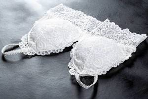 White lace bra on dark background