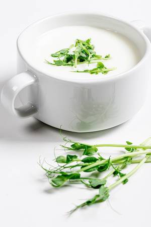 White soup with micro greenery in tureen