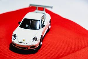 White toy car on red cloth  (Flip 2019)