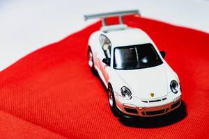 White toy car on red cloth
