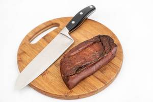 Whole piece of Smoked Ham on the wooden cutting board (Flip 2020)