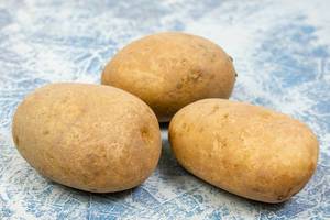 Whole Potatoes above blue background