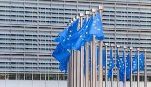 Wind blows the flags of the European Union in front of the Berlaymont Building in Brussels, Belgium