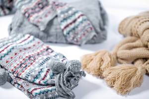 Winter warm clothes on white background