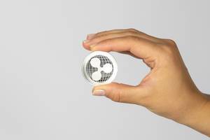 Woman holding a physical ripple coin