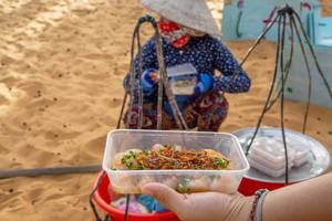 Woman selling Food at the Entrance of the Red Sand Dunes in Mui Ne