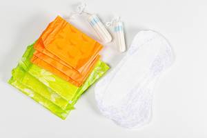 Women intimate hygiene products - sanitary pads and tampons on white background