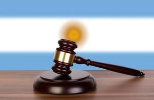 Wooden gavel and flag of Argentina