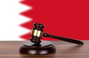 Wooden gavel and flag of Bahrain