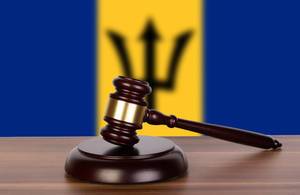Wooden gavel and flag of Barbados