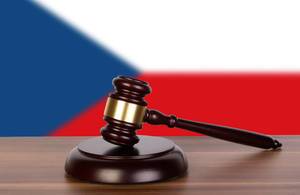 Wooden gavel and flag of Czech Republic