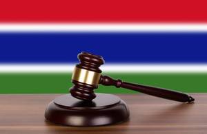 Wooden gavel and flag of Gambia
