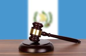 Wooden gavel and flag of Guatemala