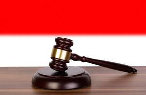 Wooden gavel and flag of Indonesia