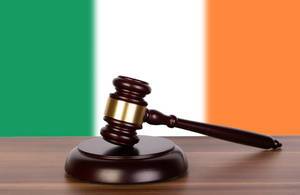 Wooden gavel and flag of Ireland