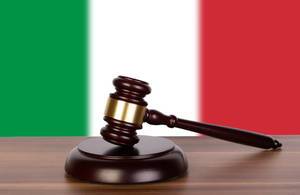 Wooden gavel and flag of Italy