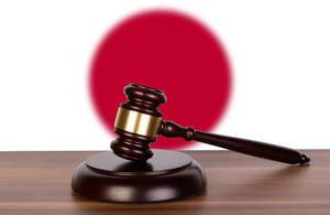 Wooden gavel and flag of Japan