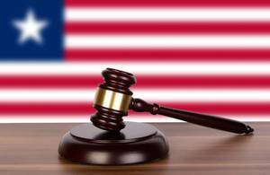 Wooden gavel and flag of Liberia