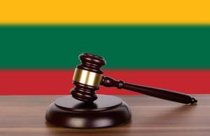 Wooden gavel and flag of Lithuania