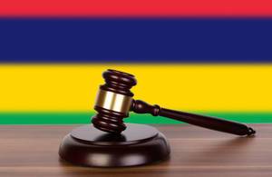 Wooden gavel and flag of Mauritius